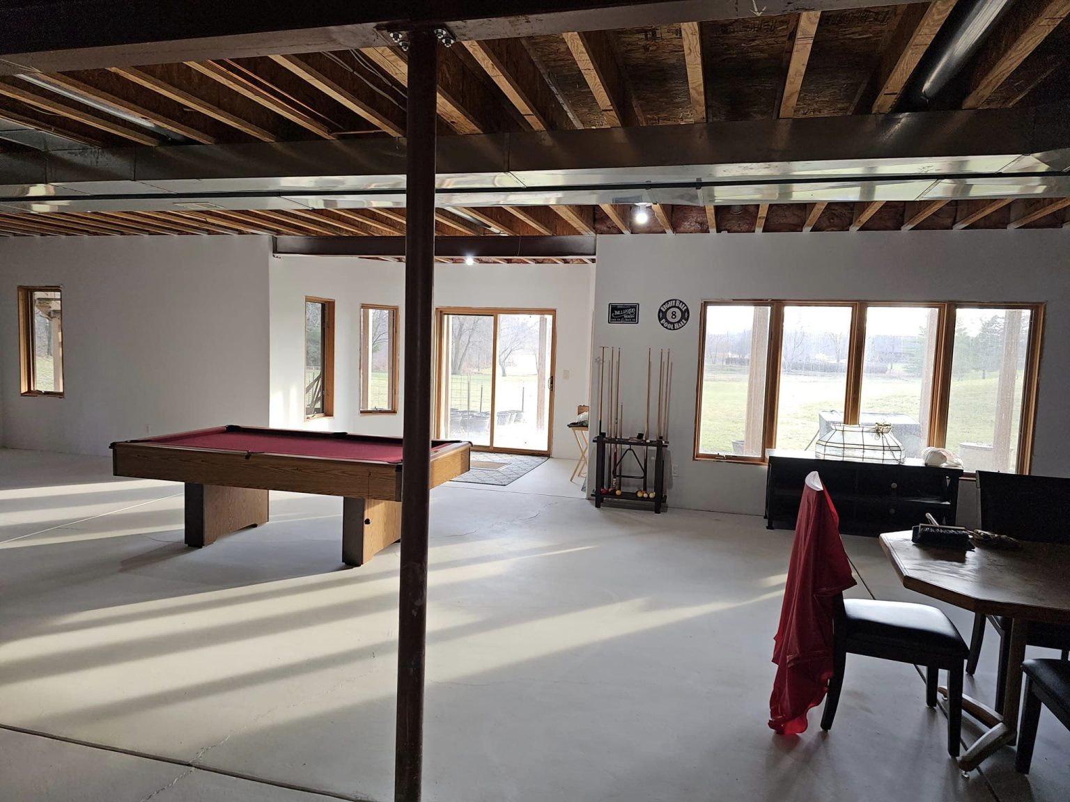 Waterford lower level before finishing, with exposed joists and a pool table